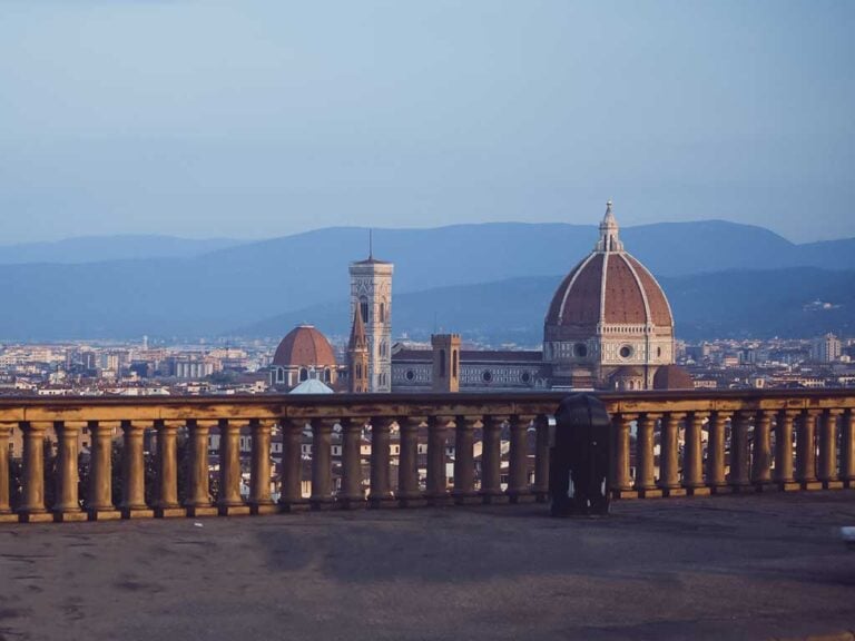 Early morning view of Florence with the Duomo and Giotto’s Bell Tower seen from Piazzale Michelangelo, lit by soft sunrise light