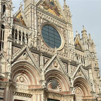 Close-up of the ornate Gothic facade of Siena Cathedral, a must-visit landmark during a Siena day trip from Florence