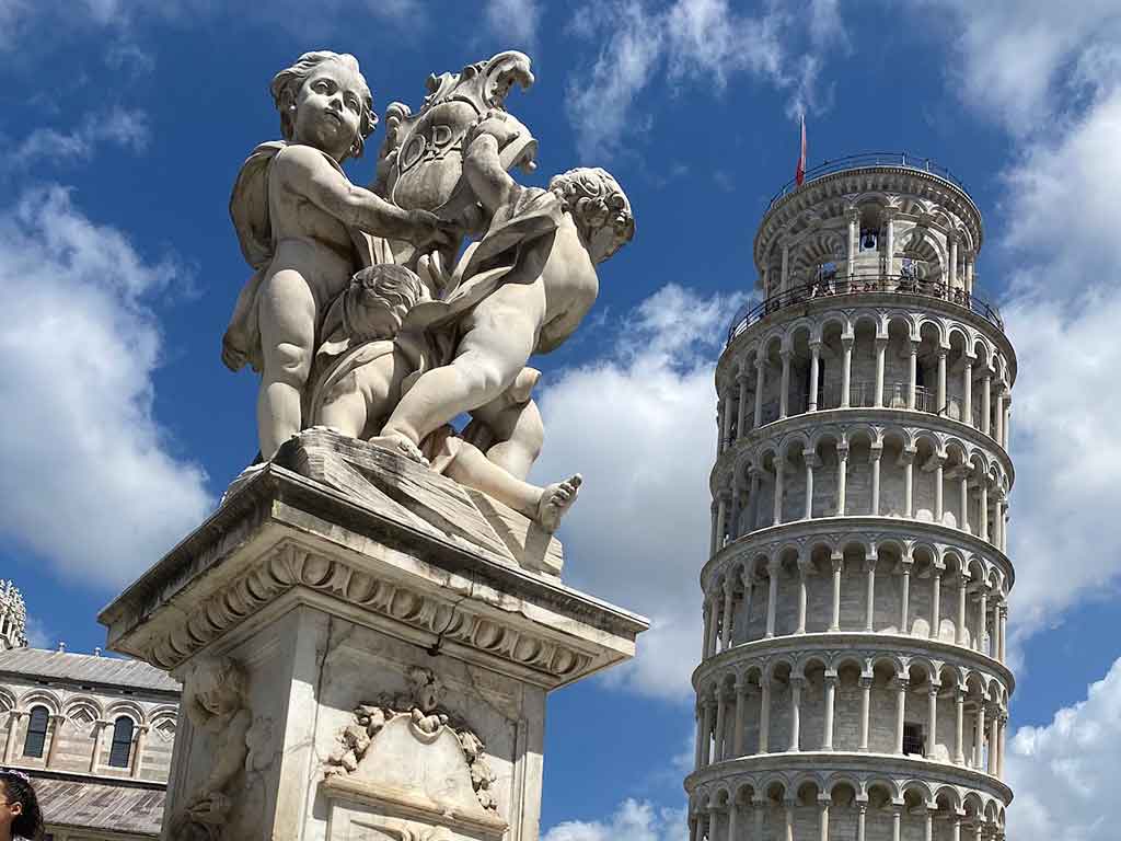 Leaning Tower of Pisa and cherub fountain in Piazza dei Miracoli, Tuscany, Italy