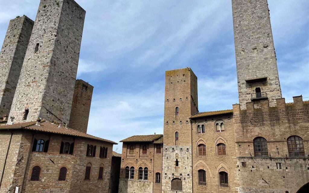 Medieval stone towers in San Gimignano, Tuscany, Italy, under a clear blue sky