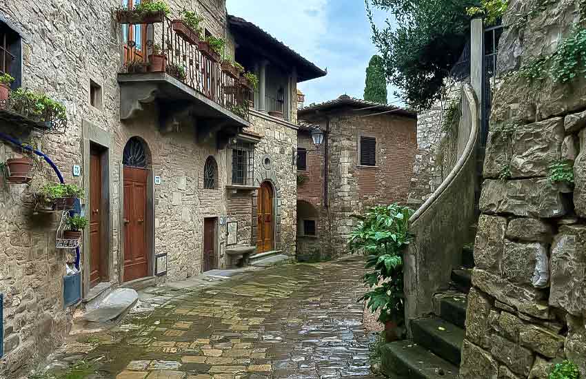 Cobblestone street and stone houses in the medieval village of Montefioralle, Tuscany, Italy