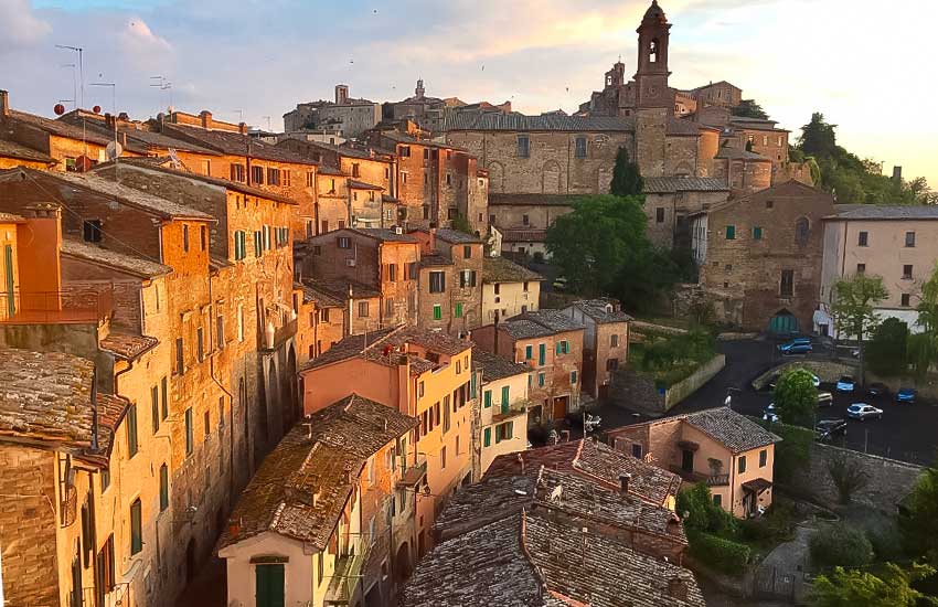 Golden sunset over the terracotta rooftops of Montepulciano in Tuscany, Italy