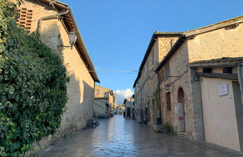 Peaceful stone street in Monteriggioni, a medieval village in Tuscany, Italy