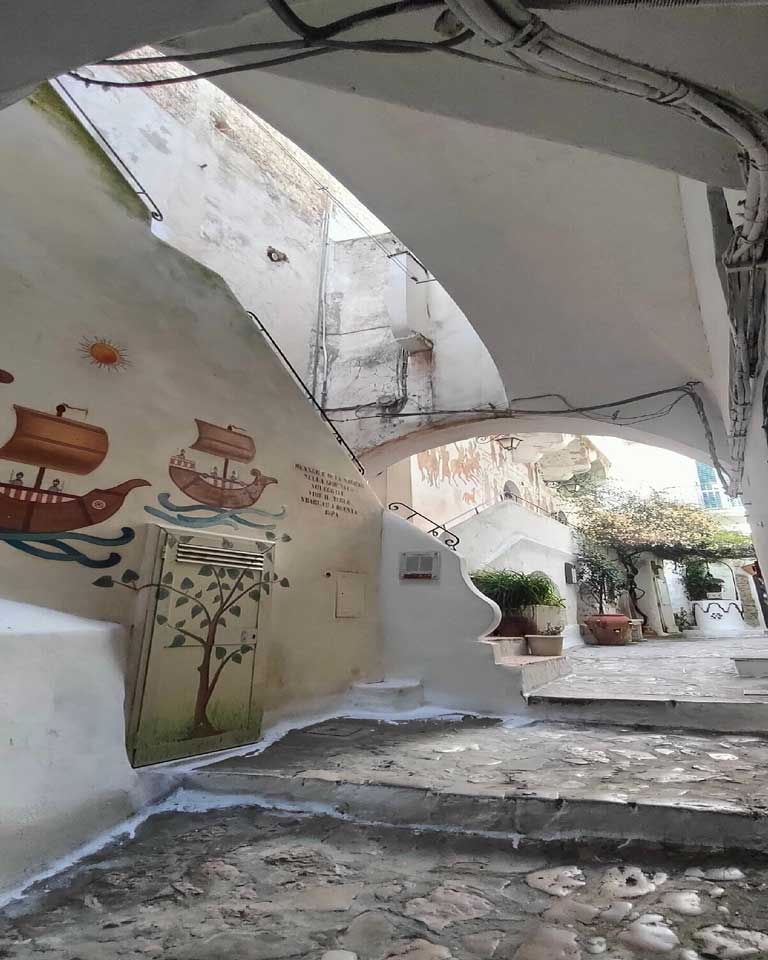 Stone steps with painted mural of ships in Sperlonga, Italy
